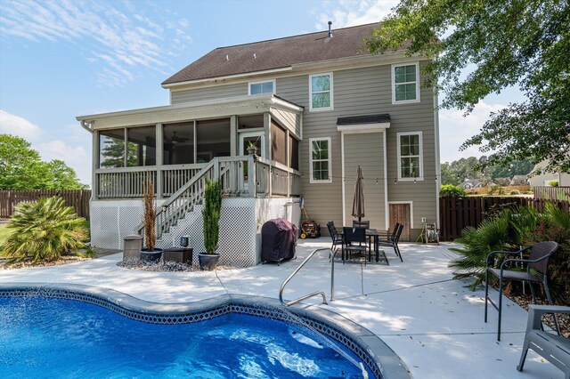 back of house featuring a sunroom, a fenced backyard, a patio area, and stairs