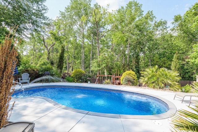 outdoor pool featuring a patio and fence