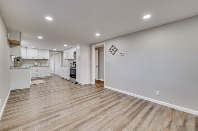 unfurnished living room with light wood-type flooring