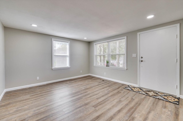 foyer entrance featuring light hardwood / wood-style flooring and a wealth of natural light