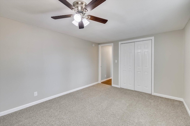 unfurnished bedroom featuring carpet, ceiling fan, and a closet