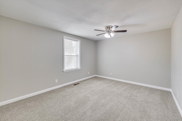 carpeted spare room with ceiling fan