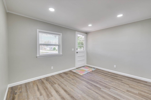 interior space featuring light wood-type flooring and ornamental molding