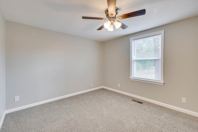 carpeted spare room with ceiling fan