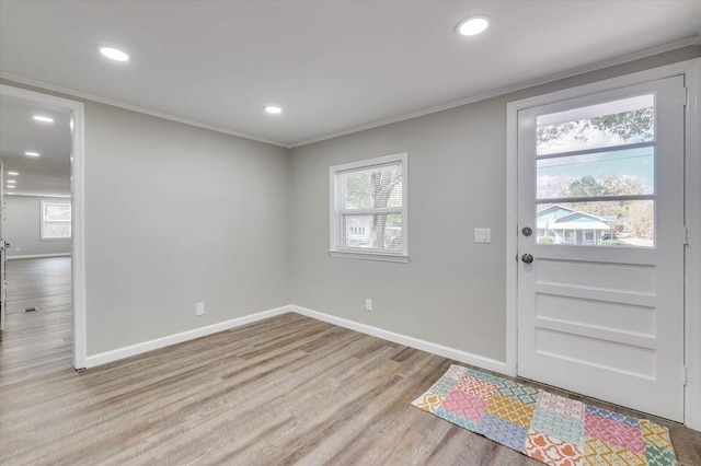 entrance foyer featuring light wood-type flooring and ornamental molding