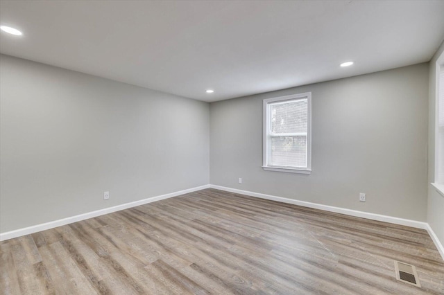 spare room featuring light hardwood / wood-style floors