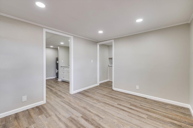 unfurnished bedroom featuring crown molding and light hardwood / wood-style floors