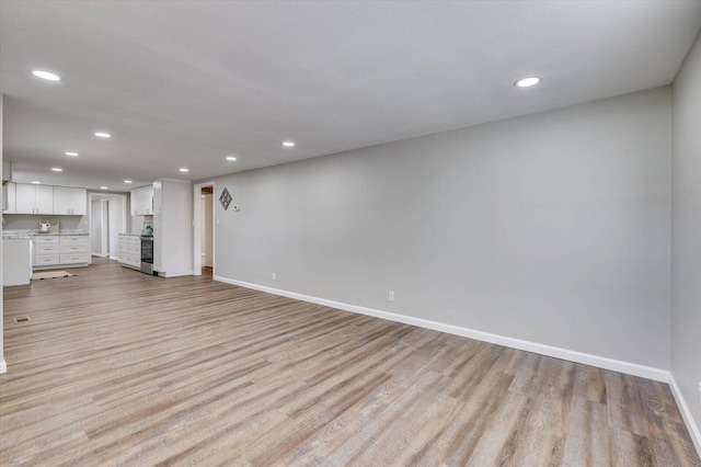 unfurnished living room with light wood-type flooring