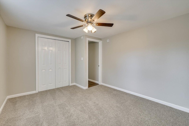 unfurnished bedroom with carpet, ceiling fan, and a closet