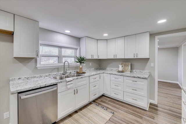 kitchen with white cabinets, dishwasher, sink, and light hardwood / wood-style flooring