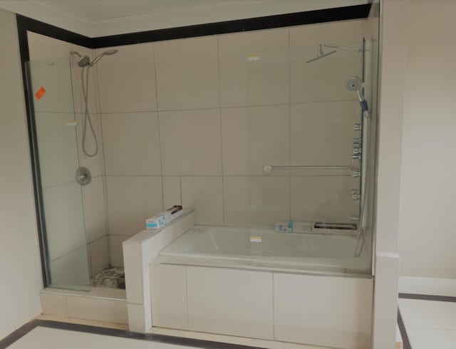 bathroom featuring shower with separate bathtub