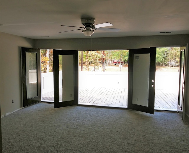 entryway with carpet flooring, plenty of natural light, and french doors