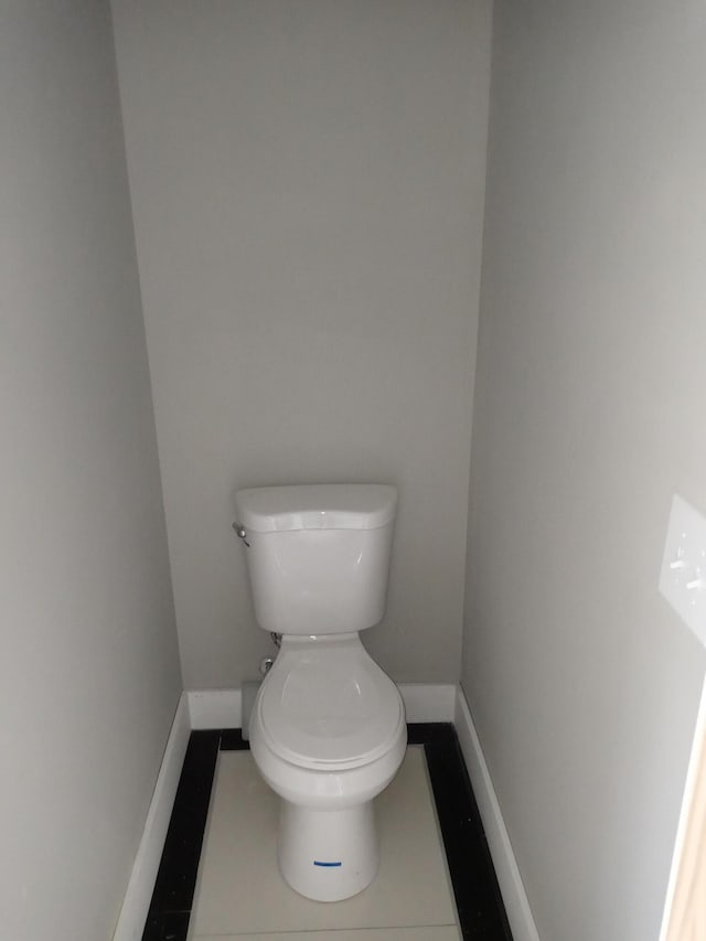 bathroom with tile patterned floors and toilet