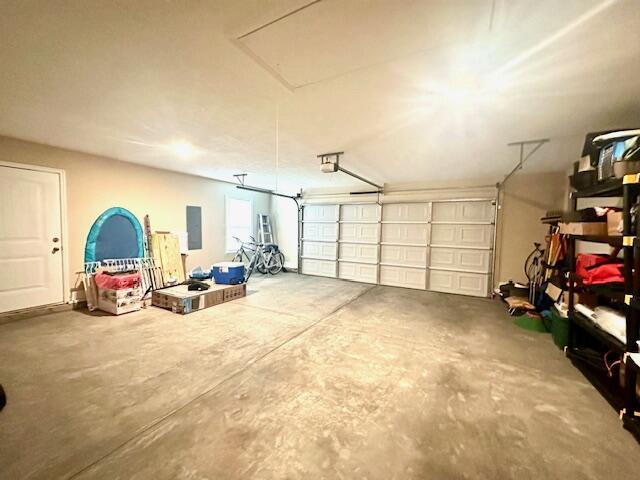 garage featuring a garage door opener and electric panel