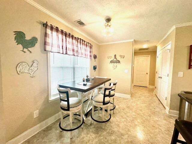 dining room with a textured ceiling and ornamental molding