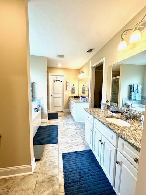 bathroom featuring vanity and shower with separate bathtub