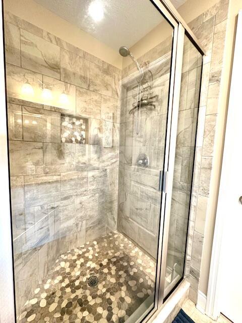 bathroom with a shower with door