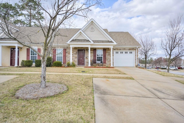 view of front of home featuring concrete driveway, stone siding, an attached garage, and a front yard