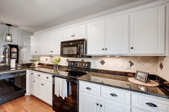 kitchen featuring black appliances, tasteful backsplash, light wood-type flooring, and white cabinets