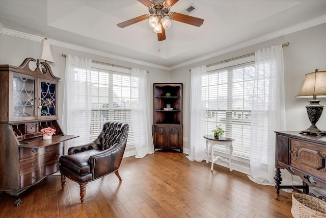 sitting room with hardwood / wood-style floors, visible vents, and a healthy amount of sunlight