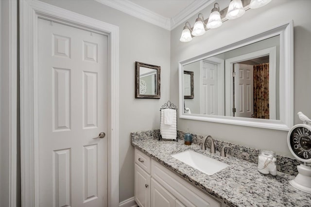 bathroom featuring ornamental molding and vanity