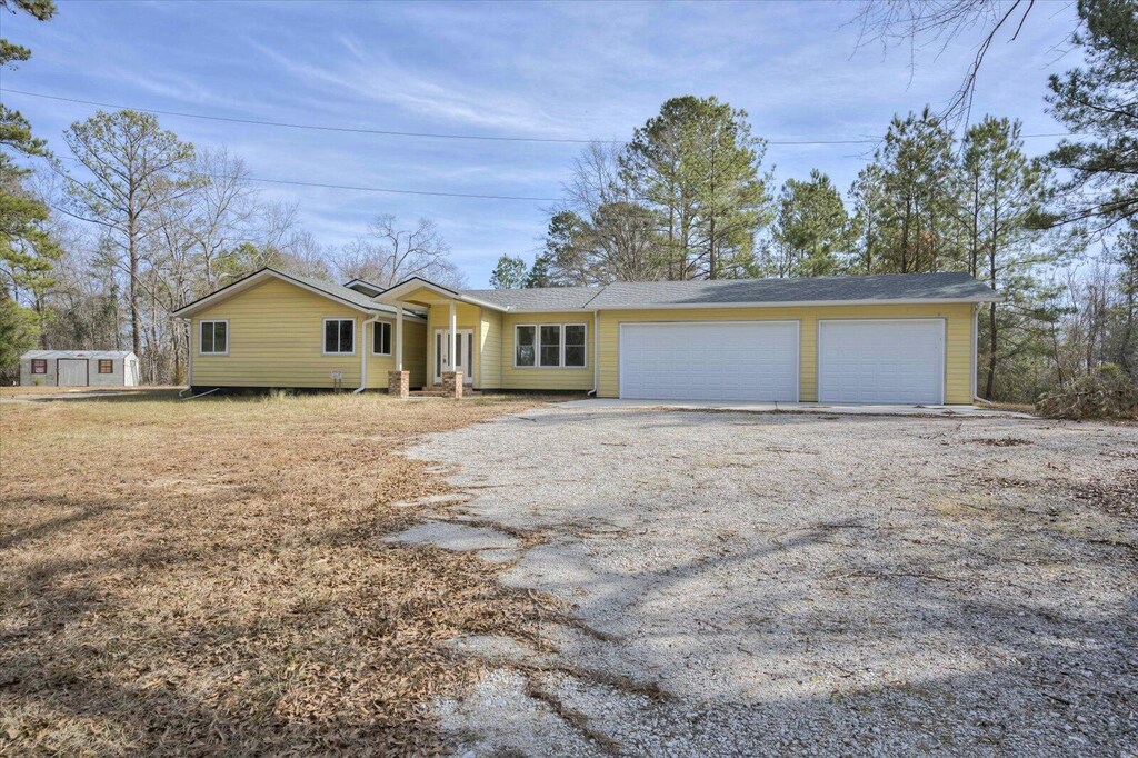 ranch-style house with a front yard and a garage