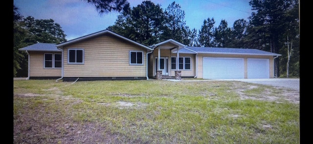 ranch-style house with a front yard and a garage