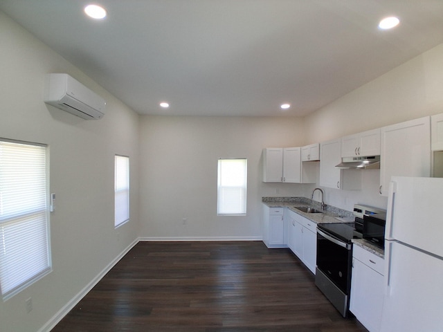 1540 Mill St, Augusta, GA 30901 - kitchen with electric range, a wall mounted air conditioner, freestanding refrigerator, a wealth of natural light, and under cabinet range hood