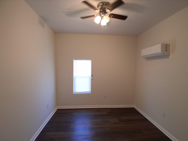 1540 Mill St, Augusta, GA 30901 - spare room featuring baseboards, a wall mounted air conditioner, dark wood finished floors, and ceiling fan