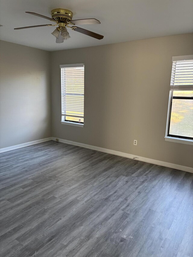 unfurnished room featuring dark hardwood / wood-style floors and ceiling fan