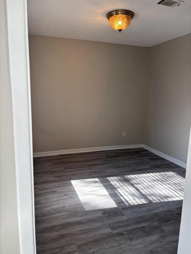 empty room with dark hardwood / wood-style floors