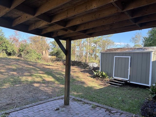 view of yard with a shed and a patio area