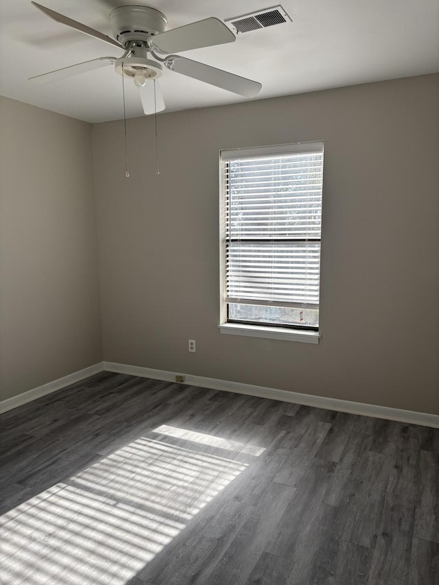 spare room with ceiling fan and dark hardwood / wood-style flooring