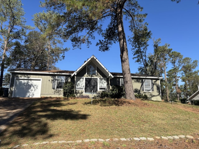 single story home featuring a front yard and a garage