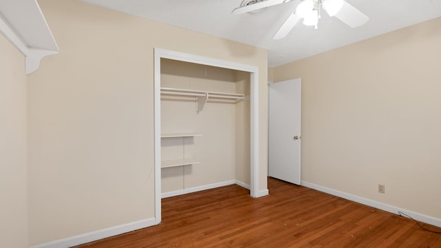 unfurnished bedroom featuring ceiling fan, a closet, wood finished floors, and baseboards