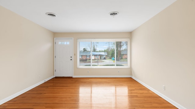 entrance foyer featuring light wood-type flooring, visible vents, and baseboards