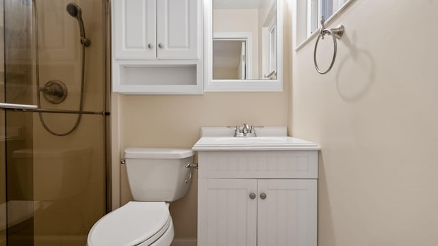 bathroom featuring toilet, an enclosed shower, and vanity