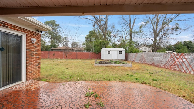 view of yard with a patio area, a fenced backyard, a storage shed, and an outbuilding