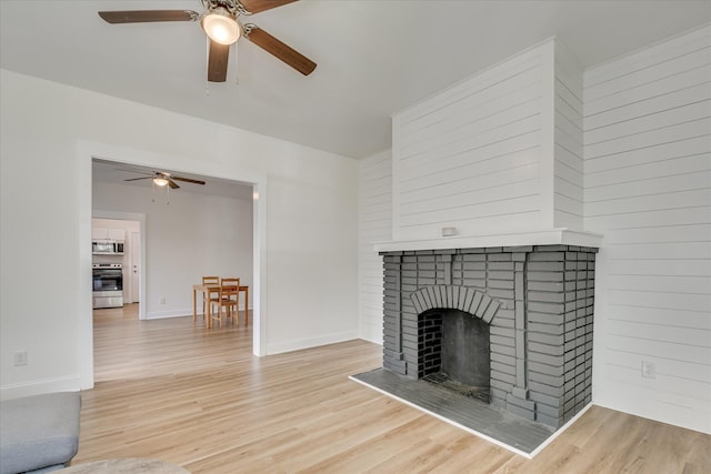 1107 Adrian St, Augusta, GA 30904 - unfurnished living room with ceiling fan, wood finished floors, a fireplace, and baseboards