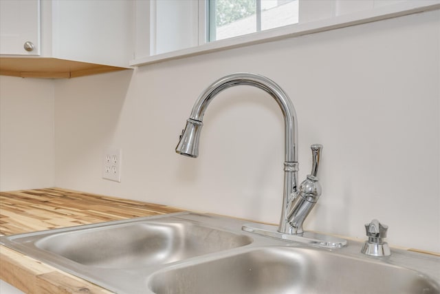 1107 Adrian St, Augusta, GA 30904 - kitchen view of a sink, white cabinets, and light countertops