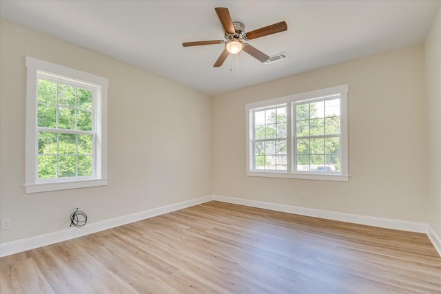 1107 Adrian St, Augusta, GA 30904 - empty room with healthy amount of natural light, light wood finished floors, and baseboards