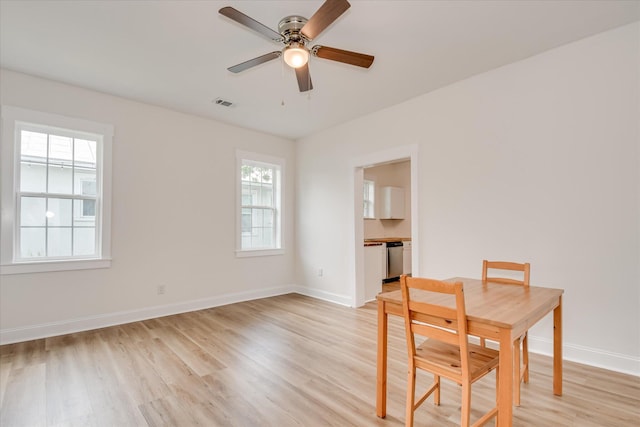 1107 Adrian St, Augusta, GA 30904 - unfurnished dining area with light wood-style floors, ceiling fan, and baseboards