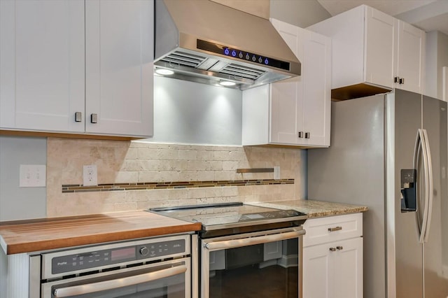 702 Southwick Ave, Grovetown, GA 30813 - kitchen with backsplash, white cabinets, butcher block counters, wall chimney exhaust hood, and stainless steel appliances