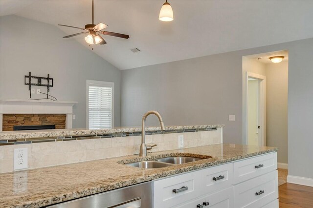 702 Southwick Ave, Grovetown, GA 30813 - kitchen with white cabinets, ceiling fan, a sink, and vaulted ceiling