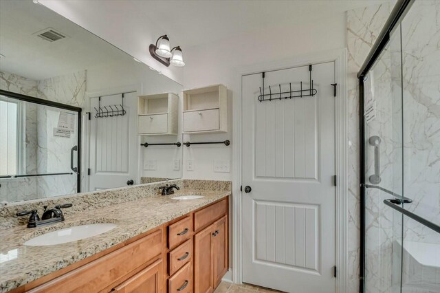 702 Southwick Ave, Grovetown, GA 30813 - bathroom with a sink, visible vents, a marble finish shower, and double vanity