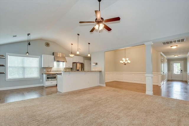 702 Southwick Ave, Grovetown, GA 30813 - unfurnished living room with visible vents, ornate columns, vaulted ceiling, ceiling fan with notable chandelier, and light wood-style flooring