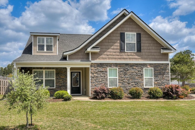702 Southwick Ave, Grovetown, GA 30813 - craftsman-style house with fence, a shingled roof, a front yard, and stone siding