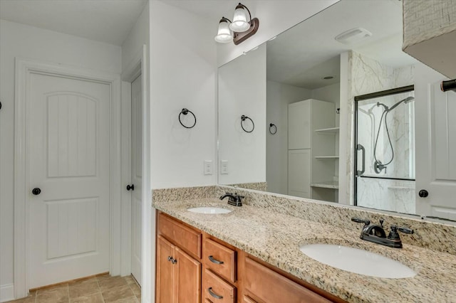 702 Southwick Ave, Grovetown, GA 30813 - bathroom featuring a shower, double vanity, visible vents, and a sink