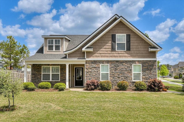 702 Southwick Ave, Grovetown, GA 30813 - craftsman inspired home with a shingled roof, fence, stone siding, and a front lawn