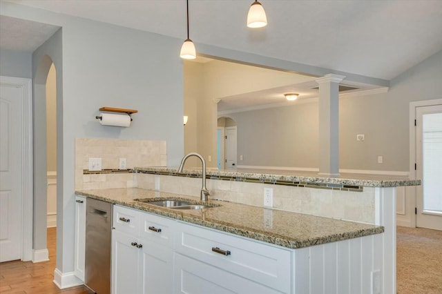 702 Southwick Ave, Grovetown, GA 30813 - kitchen with light stone countertops, decorative backsplash, arched walkways, dishwasher, and a sink